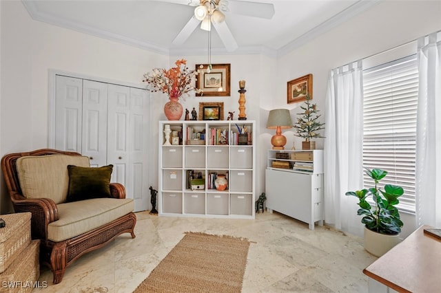 living area with ceiling fan and crown molding