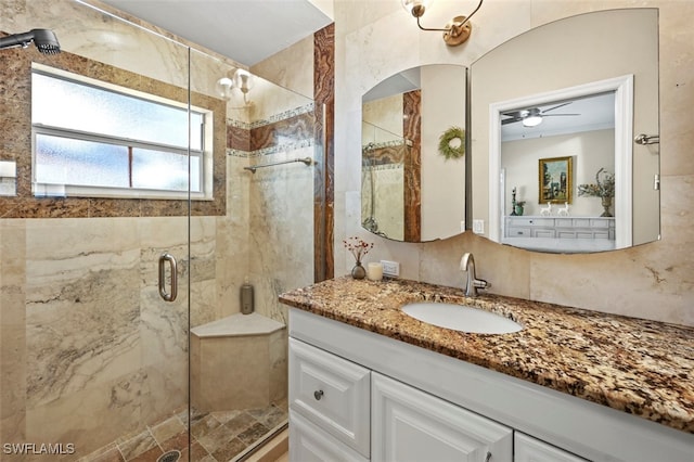 bathroom with tasteful backsplash, ceiling fan, vanity, and a shower with shower door