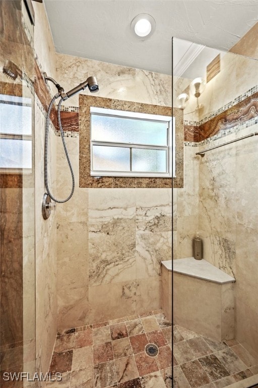 bathroom featuring ornamental molding and tiled shower