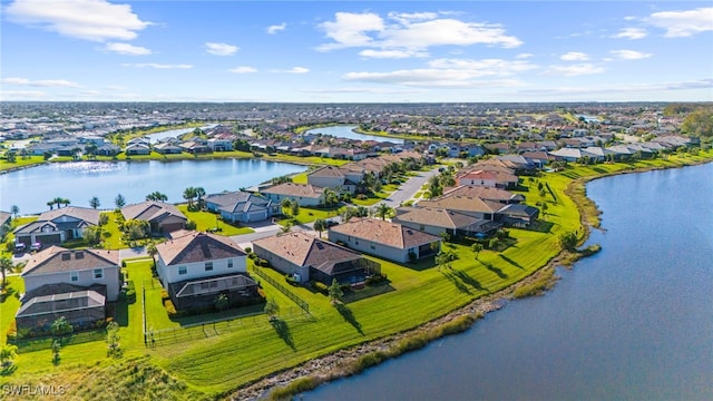 birds eye view of property with a water view and a residential view