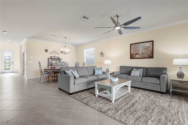 tiled living room featuring ornamental molding, visible vents, baseboards, and ceiling fan with notable chandelier