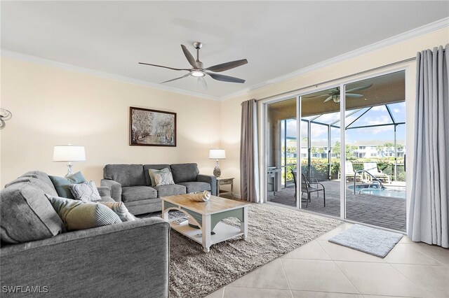 living area featuring ceiling fan, tile patterned flooring, a sunroom, and crown molding