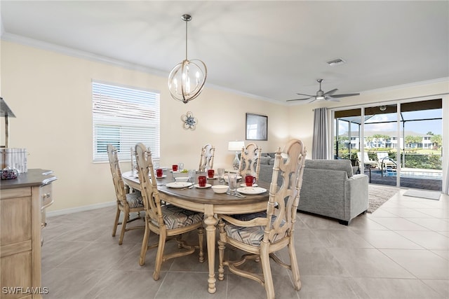 dining space featuring visible vents, ornamental molding, light tile patterned flooring, baseboards, and ceiling fan with notable chandelier