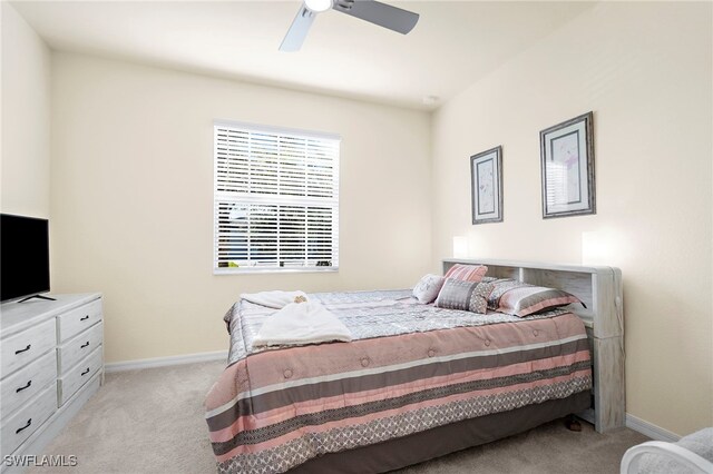 bedroom with light carpet, a ceiling fan, and baseboards