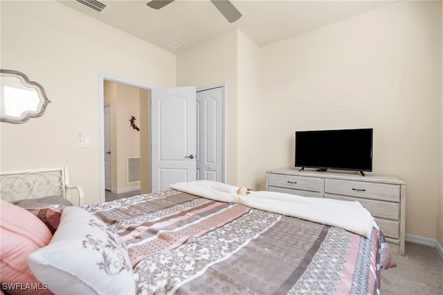 carpeted bedroom with ceiling fan and a closet