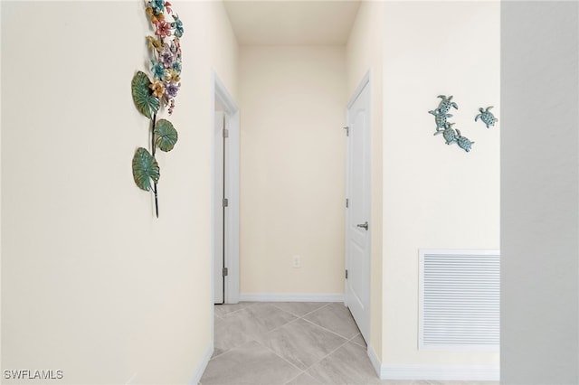 hall featuring light tile patterned floors