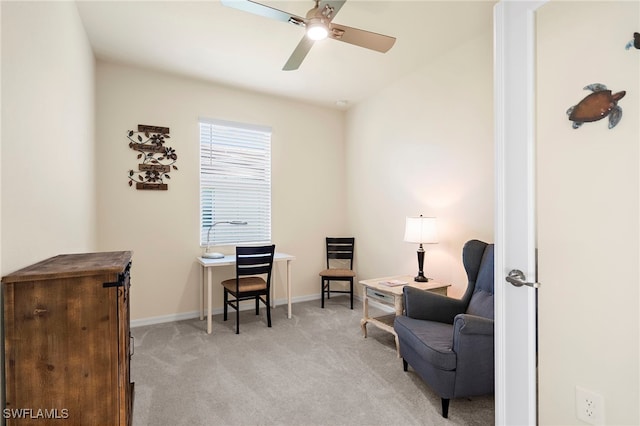 sitting room featuring ceiling fan, baseboards, and light colored carpet