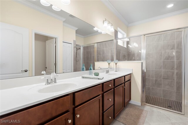 bathroom with tile patterned flooring, vanity, a shower with door, and ornamental molding