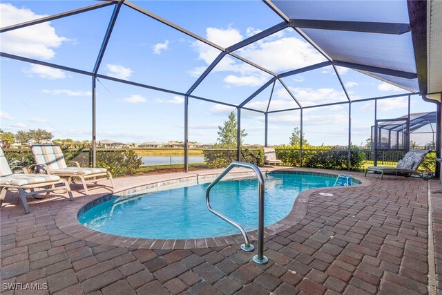 view of pool featuring a patio, a water view, and a lanai