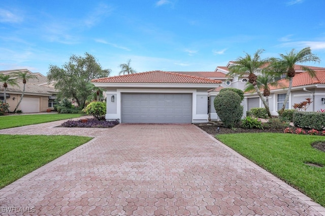 view of front facade with a garage and a front lawn