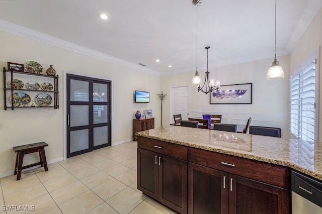 kitchen with light stone countertops, a chandelier, pendant lighting, light tile patterned flooring, and ornamental molding