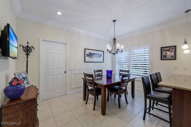 tiled dining space featuring a chandelier and ornamental molding