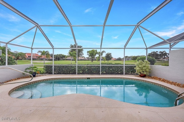 view of swimming pool featuring a lanai