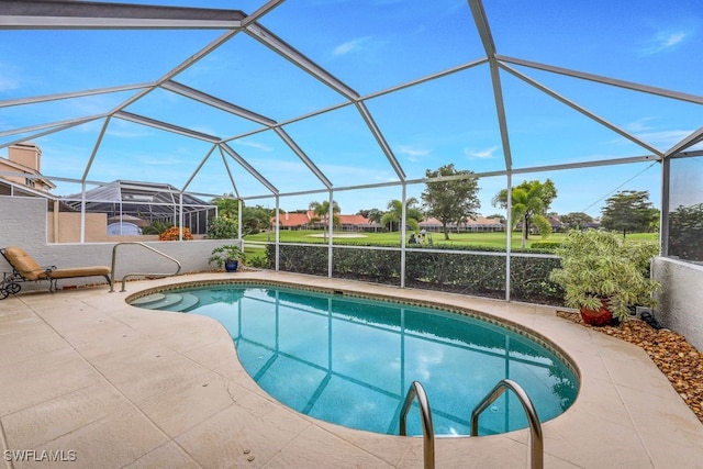 view of pool featuring a patio and glass enclosure