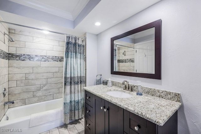 bathroom featuring vanity, shower / bathtub combination with curtain, and ornamental molding