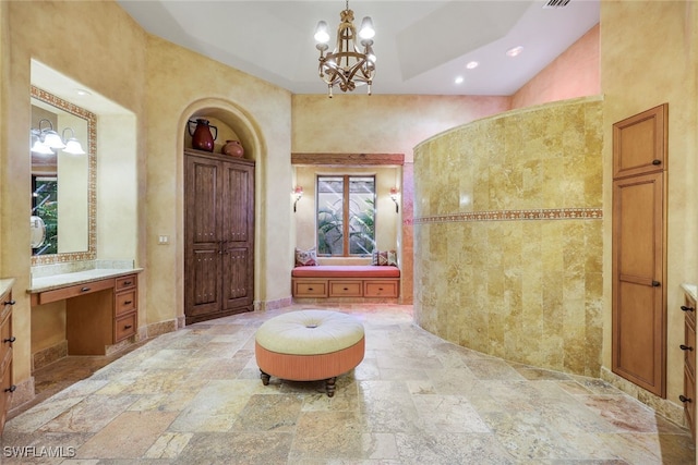 bathroom with vanity and a chandelier