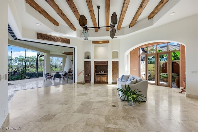 living room featuring beam ceiling and ceiling fan