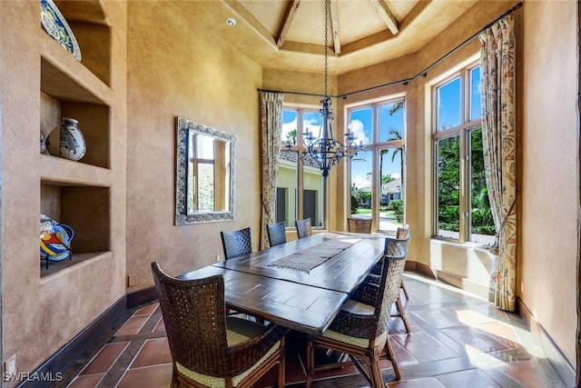 dining space featuring a high ceiling and an inviting chandelier