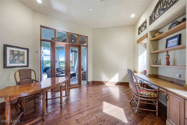 home office featuring wood-type flooring, built in desk, and french doors