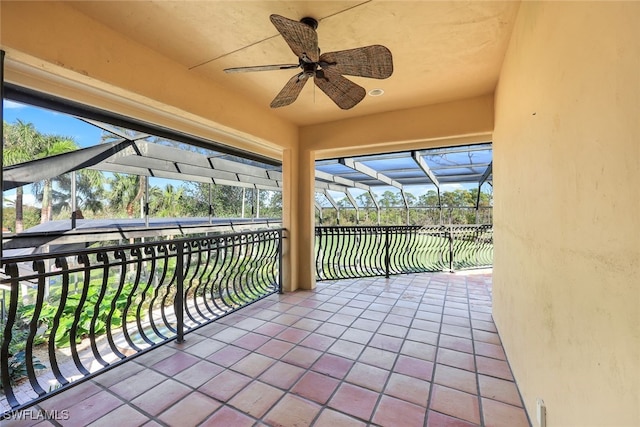 view of patio with ceiling fan and a lanai