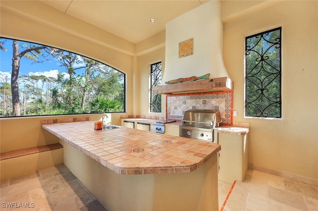 view of patio featuring grilling area, sink, and an outdoor kitchen