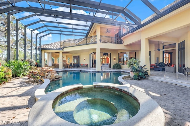 view of swimming pool featuring ceiling fan, a patio area, an outdoor living space, and an in ground hot tub