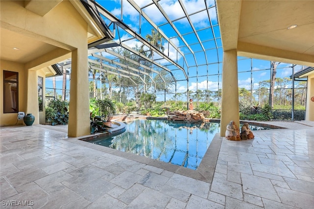 view of pool with a patio area and a lanai