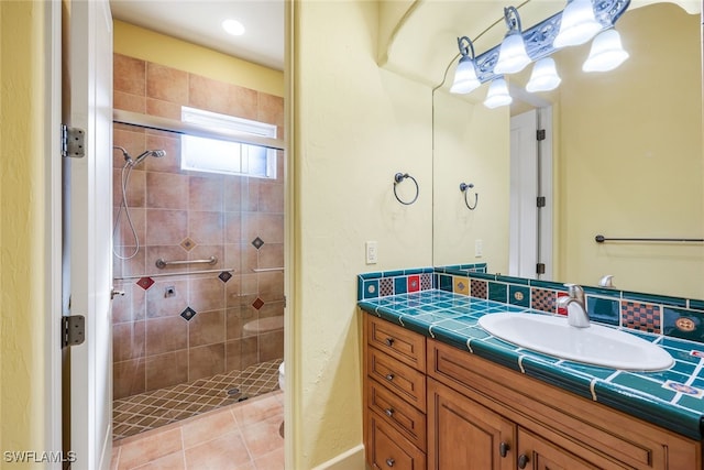 bathroom featuring tile patterned floors, vanity, toilet, and a shower with door