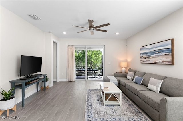 living room featuring ceiling fan and wood-type flooring