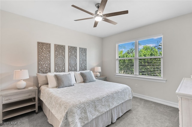 bedroom featuring light colored carpet and ceiling fan