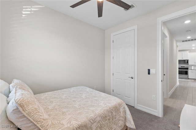 bedroom featuring light colored carpet and ceiling fan