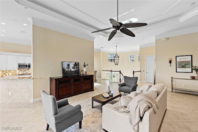 living room with baseboard heating, ceiling fan, light tile patterned floors, and ornamental molding