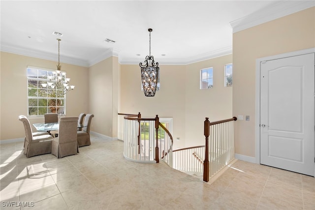 interior space featuring a notable chandelier, light tile patterned floors, and crown molding