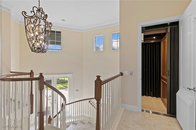 stairs with ornamental molding, tile patterned floors, and a notable chandelier