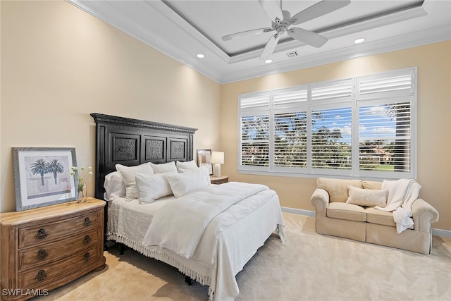 carpeted bedroom featuring ceiling fan, crown molding, and a tray ceiling