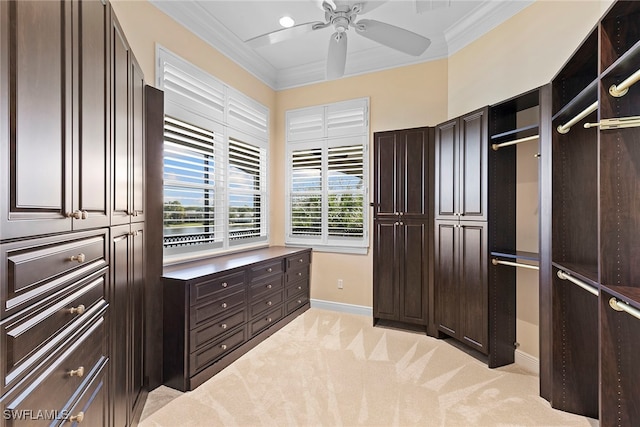 walk in closet with light carpet and ceiling fan