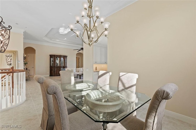 dining area with ceiling fan with notable chandelier, arched walkways, crown molding, light tile patterned floors, and baseboards