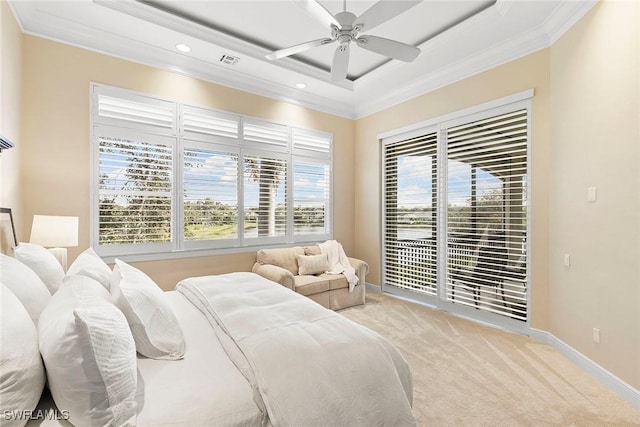 bedroom featuring visible vents, crown molding, baseboards, light colored carpet, and a raised ceiling