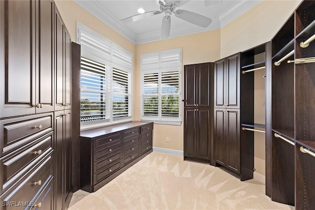 spacious closet featuring light colored carpet and a ceiling fan