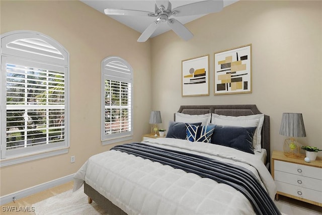 carpeted bedroom featuring baseboards and a ceiling fan