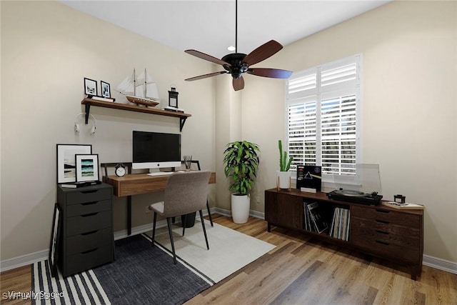 office area featuring baseboards, ceiling fan, and wood finished floors