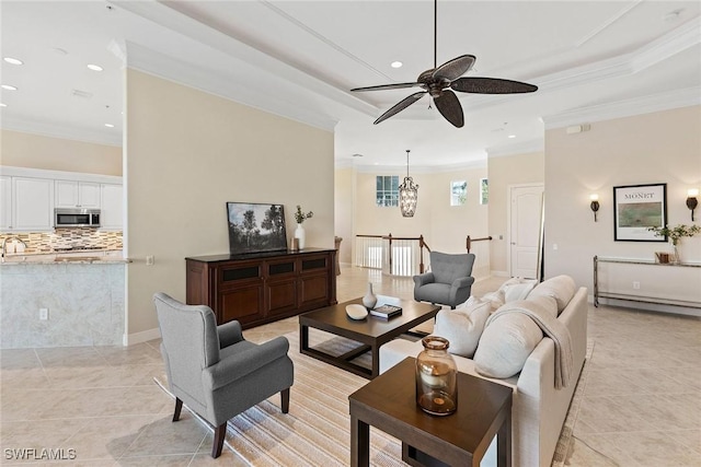 28551 Calabria Ct Unit 202, Naples, FL 34110 - living area featuring a baseboard heating unit, ornamental molding, recessed lighting, a tray ceiling, and ceiling fan with notable chandelier