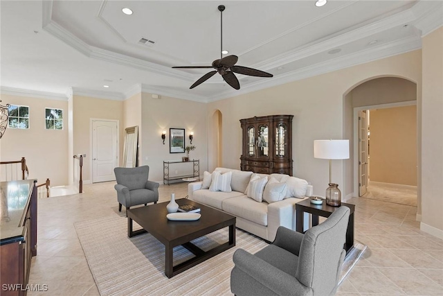 28551 Calabria Ct Unit 202, Naples, FL 34110 - living room with crown molding, arched walkways, a ceiling fan, visible vents, and a raised ceiling