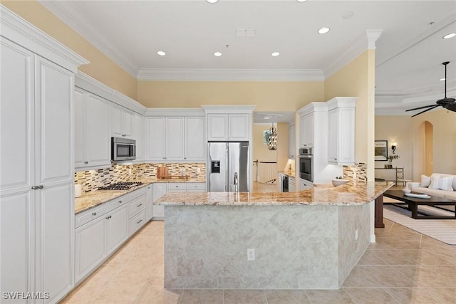 28551 Calabria Ct Unit 202, Naples, FL 34110 - kitchen with arched walkways, a peninsula, appliances with stainless steel finishes, light tile patterned flooring, and light stone counters
