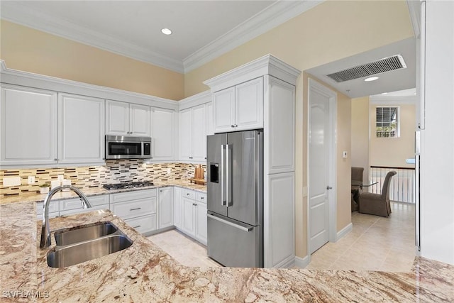 28551 Calabria Ct Unit 202, Naples, FL 34110 - kitchen with light stone counters, white cabinetry, visible vents, stainless steel appliances, and a sink