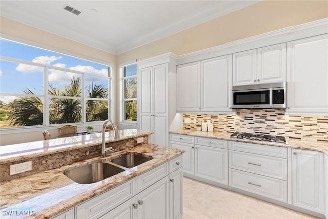 28551 Calabria Ct Unit 202, Naples, FL 34110 - kitchen with white cabinetry, visible vents, decorative backsplash, stainless steel appliances, and a sink