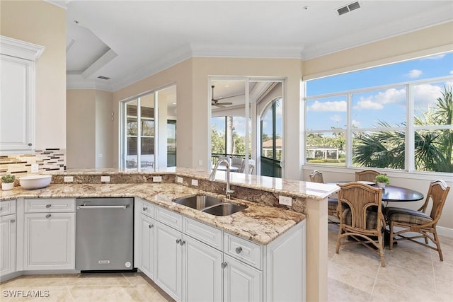 28551 Calabria Ct Unit 202, Naples, FL 34110 - kitchen featuring light stone countertops, ornamental molding, white cabinets, visible vents, and a sink