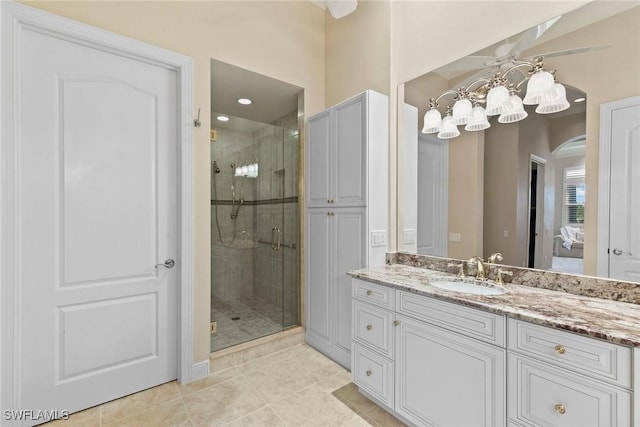 28551 Calabria Ct Unit 202, Naples, FL 34110 - bathroom with a stall shower, vanity, a notable chandelier, and tile patterned floors