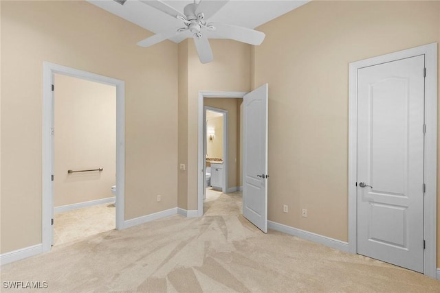 28551 Calabria Ct Unit 202, Naples, FL 34110 - unfurnished bedroom with light colored carpet, ensuite bathroom, and baseboards