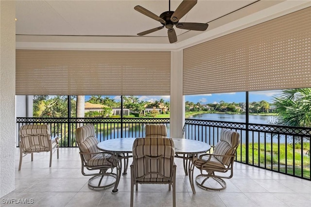 28551 Calabria Ct Unit 202, Naples, FL 34110 - sunroom featuring a water view, ceiling fan, outdoor dining area, and a healthy amount of sunlight